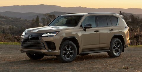 Lexus LX600 parked at dusk with mountains behind.